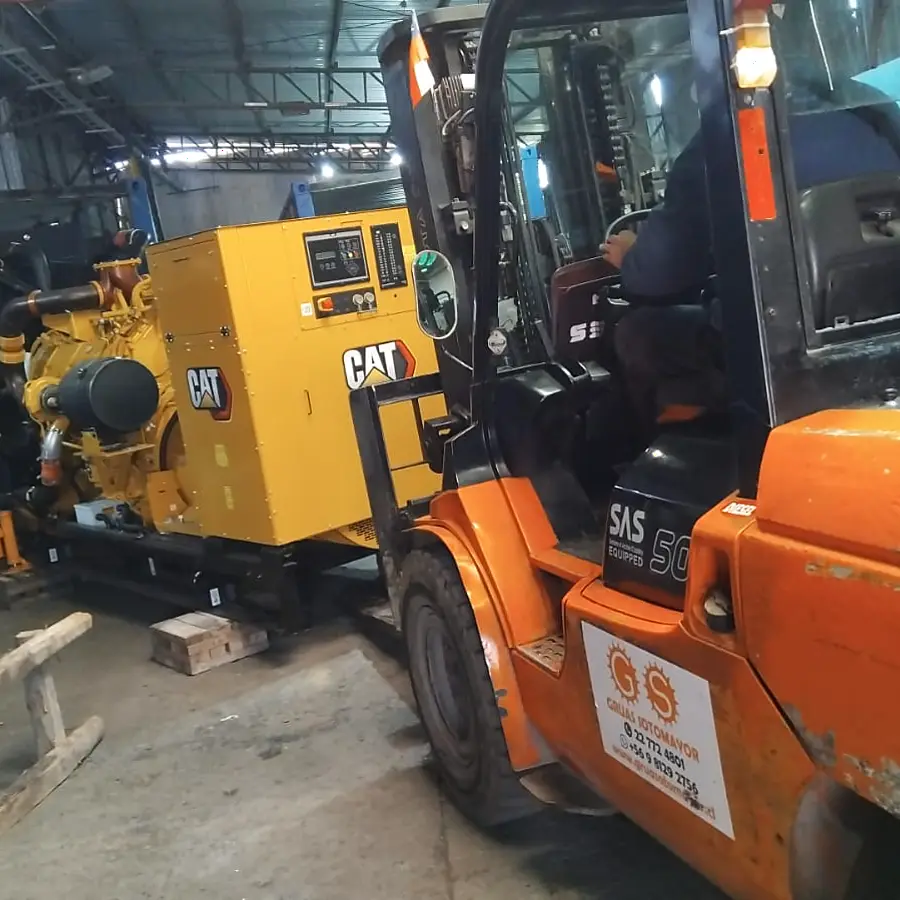 Grúa horquilla trasladando un motor CAT dentro de una planta industrial